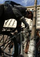A girl ties a bicycle to the tree