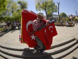 A man carries the flags of Turkey