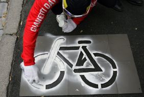A bicyclist draws the sign of bicycle path