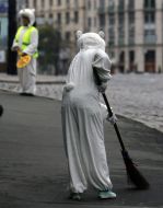 A bicyclist sweeps a street