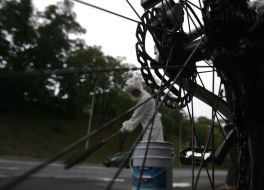 A bicyclist sweeps a street