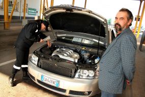 Frontiersman inspects a car