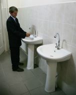A boy washes his hands