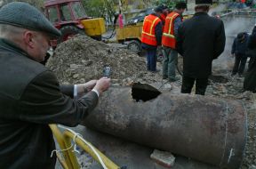 A passer-by takes pictures hole in a pipe