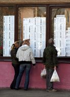 Passers-by learn the lists with deputies candidates