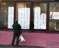 Passer-by reads the lists with deputies candidates