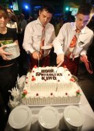 Waiters cut a cake