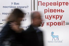 Passers-by near a placard