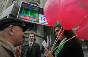 A girl distributes minicards of ”PrivatBank” with the brand of MasterCard
