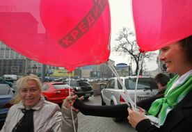 A girl distributes minicards of ”PrivatBank” with the brand of MasterCard