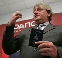 Aleksandr Dranikov demonstrates the passport officer INTERPOL