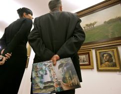 Visitors examine pictures