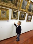 A boy examines pictures