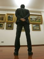 A man examines pictures
