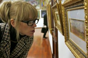 A visitor examines pictures