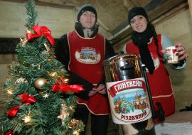 Salespeople pour out mulled wine