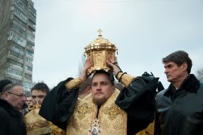 Bishop Joseph holds the shrine with the relics