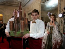 Waiters pass a chocolate castle