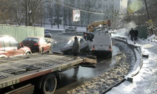 Concrete box unitslie on the hood of car