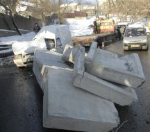 Concrete box unitslie on the hood of car