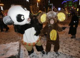 Young people in the suits of cheburashka and bear