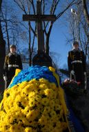 Laying-on of flowers to the memorable sign to Heroes Kruty