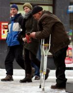 An elderly man begs for charity