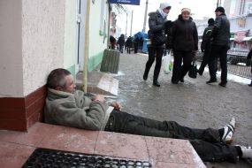 Drunk man sleeping on sidewalk