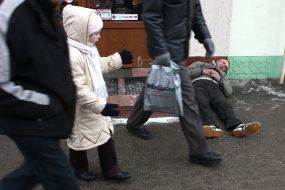 Drunk man sleeping on sidewalk