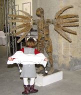 Girl examines sculpture