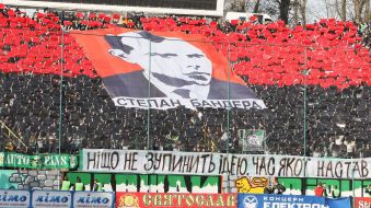 Fans hold the portrait of Stepan Bandera