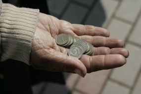 A woman holds copecks in a palm