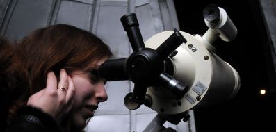 The Girl looks through a telescope on the Moon