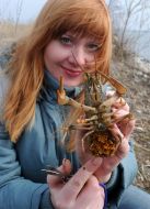 A girl holds the crawfish