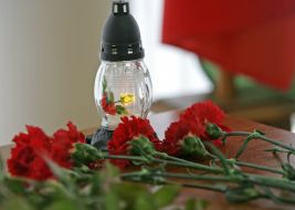 Carnations near a candle