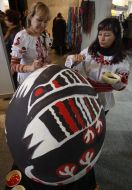 Women paint big Easter egg