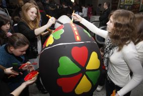 Girls paint big Easter egg