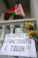 Placard, flowers and flag