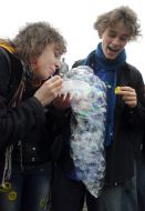 Young people inflate soap-bubbles