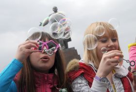 Young people inflate soap-bubbles