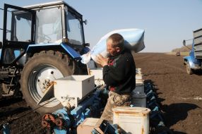 A worker carries a sack