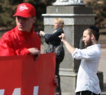 A man takes pictures participants of demonstration