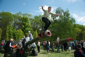 A boy stands on a gun