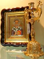 Gilded candlestick and icon of Saint Nicholas