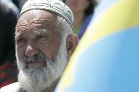 A man near the flag of Crimean Tatars