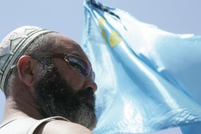 A man near the flag of Crimean Tatars