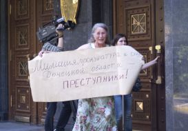 Woman with a placard near building of general prosecution