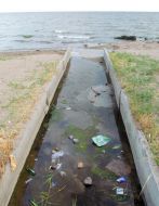 Ditch with sewers waters flowing into the sea