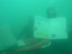 Journalists-divers making up a newspaper under the water