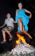 Mom and son jump over the fire
